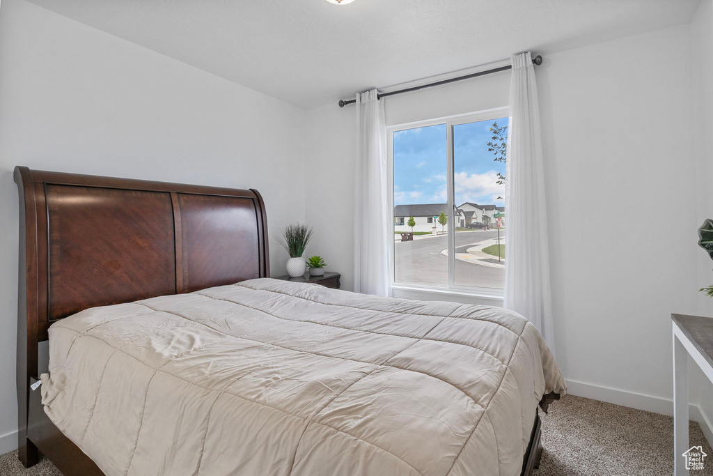 Bedroom with carpet and baseboards