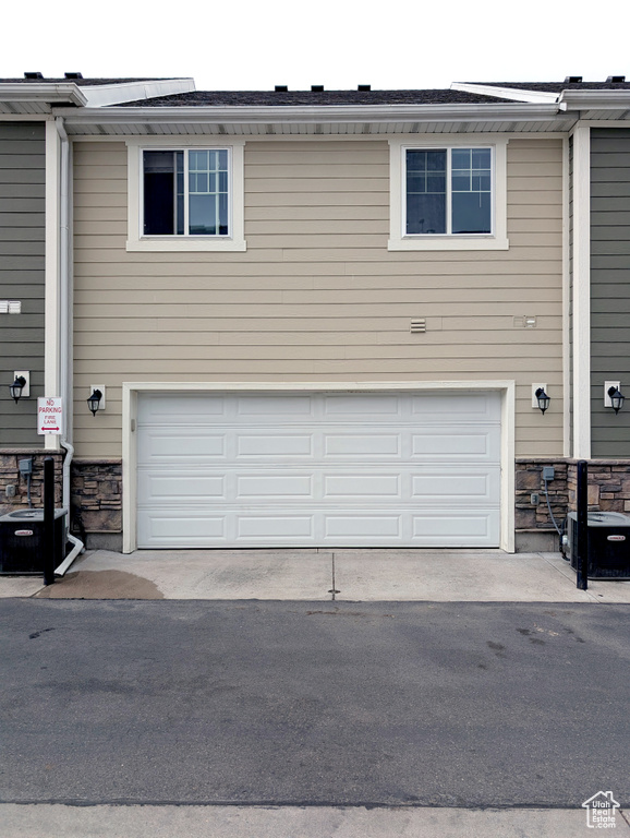 Garage with cooling unit and driveway