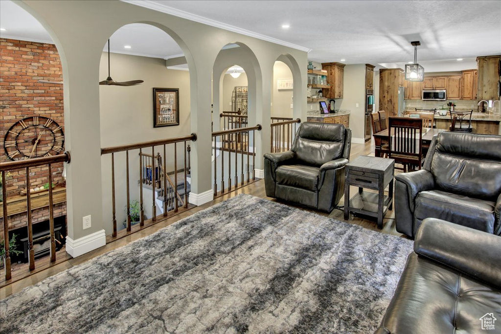 Living area featuring recessed lighting, a ceiling fan, light wood-style floors, and baseboards