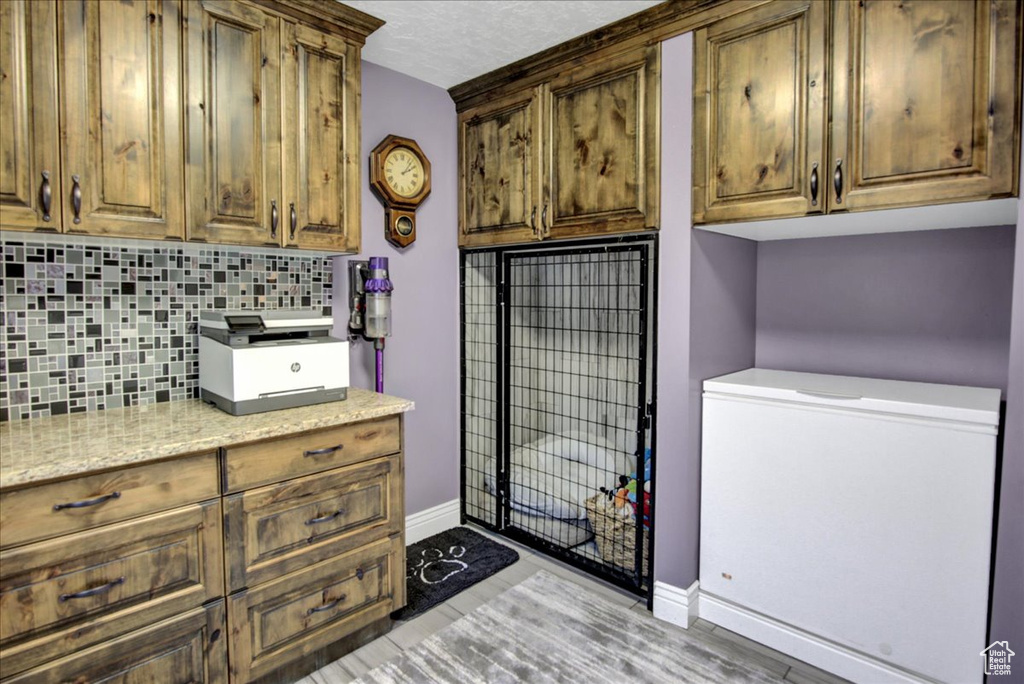 Clothes washing area with baseboards