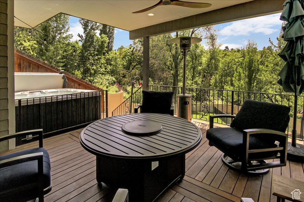 Wooden terrace featuring ceiling fan