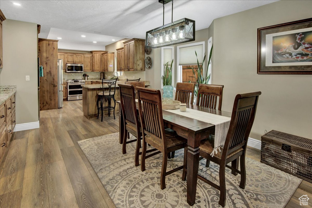 Dining area featuring light wood-style flooring, recessed lighting, and baseboards