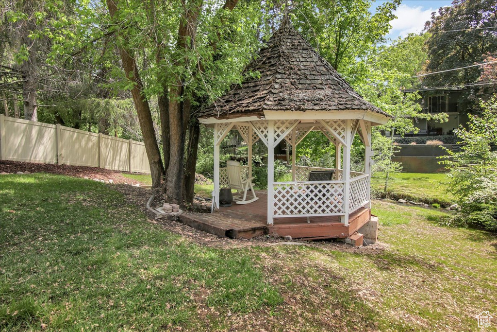 View of yard with a gazebo and a wooden deck