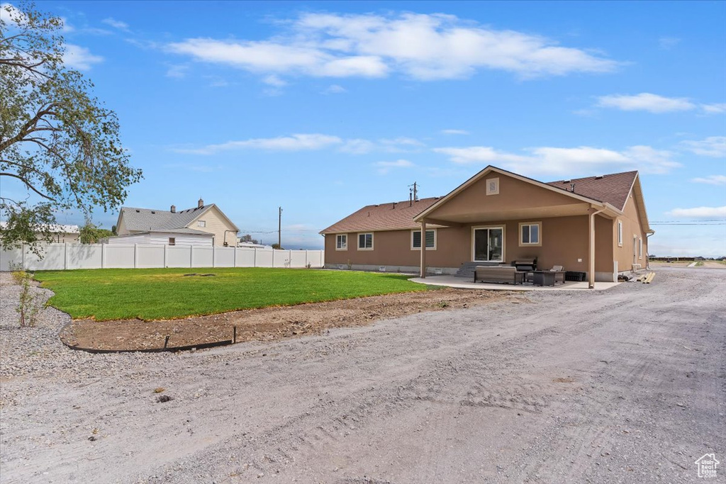 View of front of home featuring a patio area and stucco siding