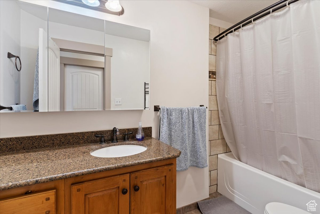 Full bath featuring vanity and shower / bath combo