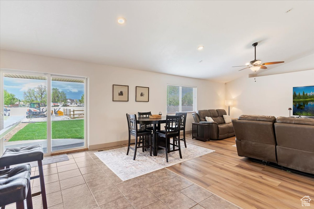 Dining room featuring a ceiling fan, light tile patterned flooring, vaulted ceiling, and recessed lighting