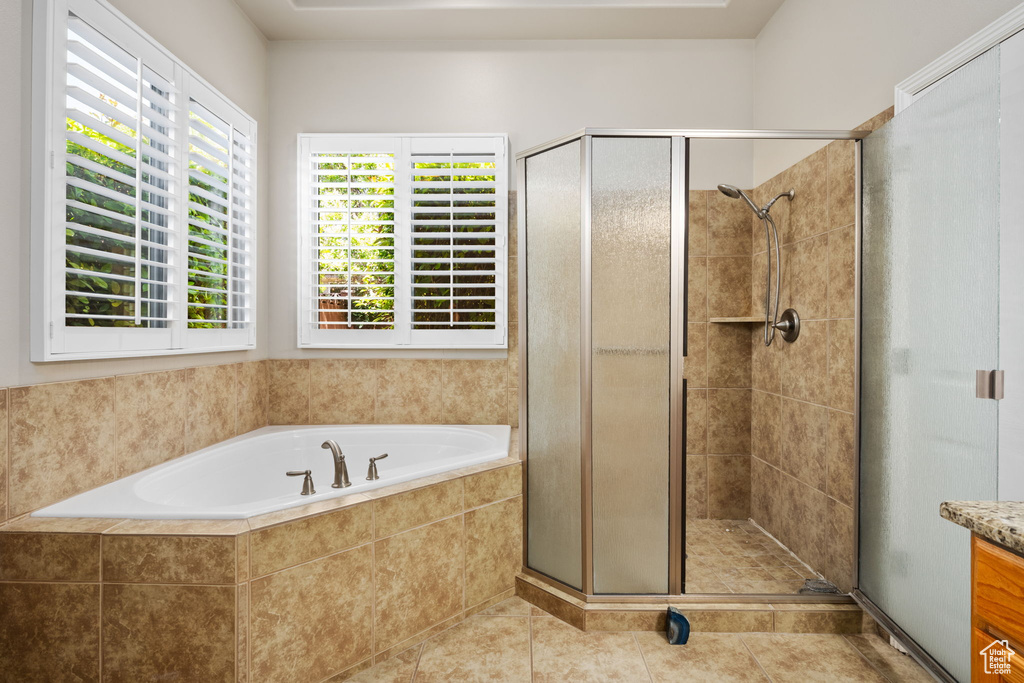 Full bath with a shower stall, a bath, vanity, and tile patterned floors