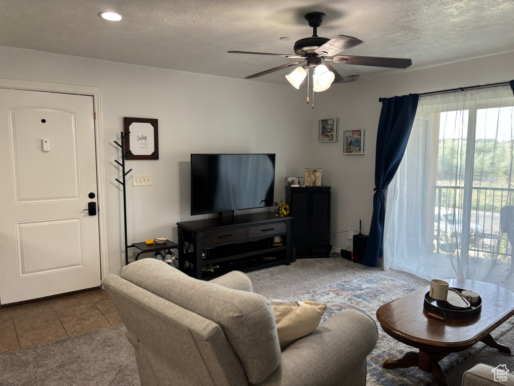 Living room featuring ceiling fan, a textured ceiling, recessed lighting, and tile patterned flooring