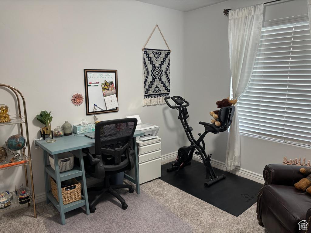 Carpeted office space featuring baseboards