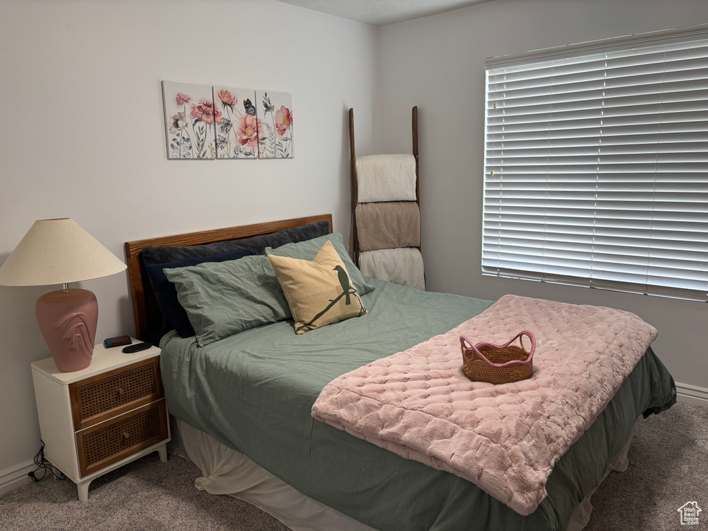 Bedroom featuring carpet flooring and baseboards