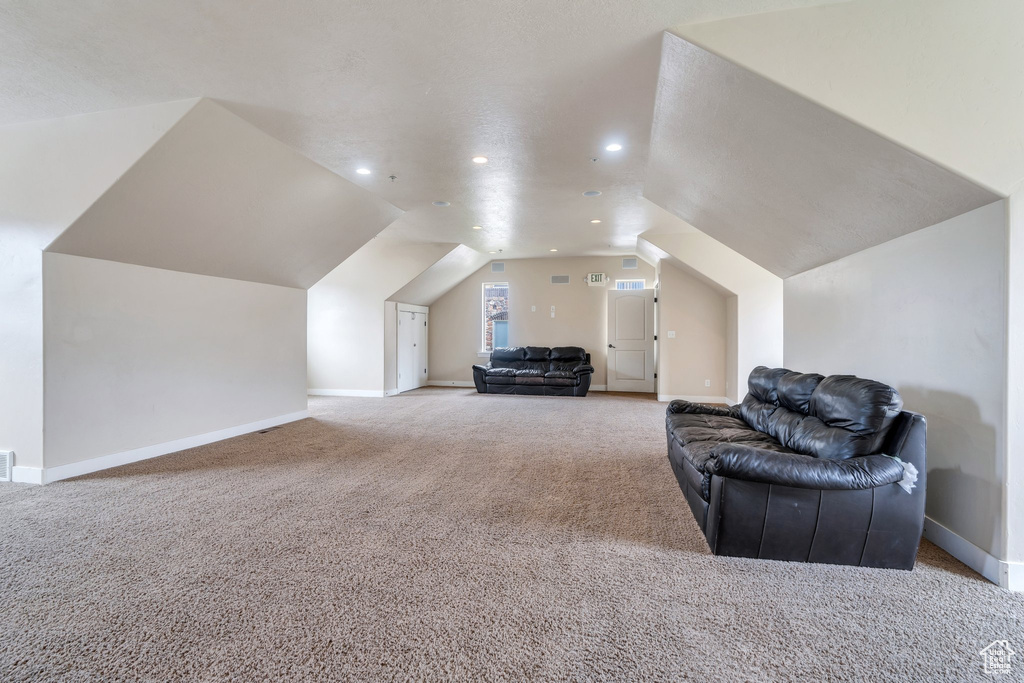 Additional living space with carpet, lofted ceiling, baseboards, and recessed lighting