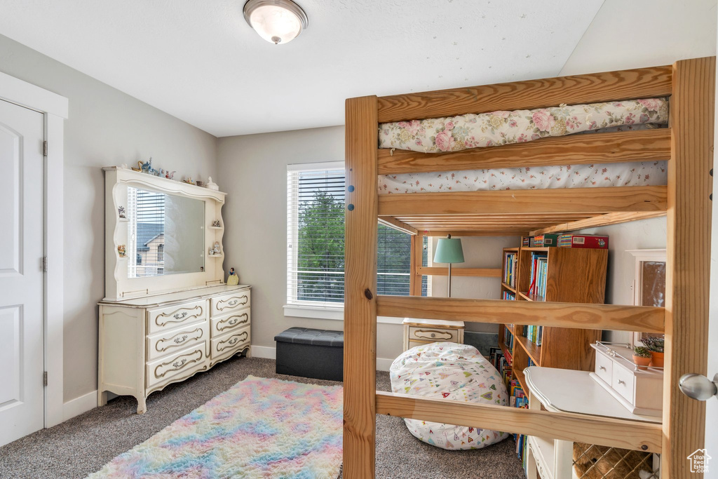 Bedroom featuring carpet floors and baseboards