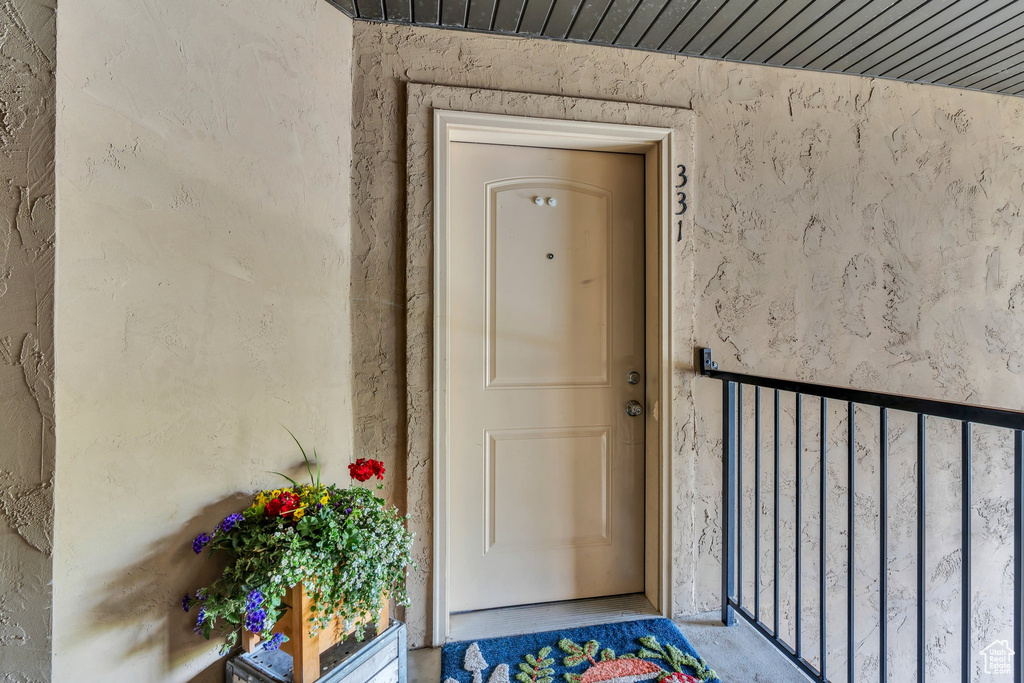 Property entrance featuring stucco siding