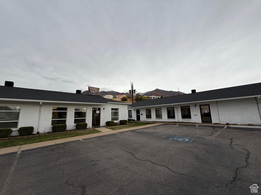 View of building exterior featuring uncovered parking