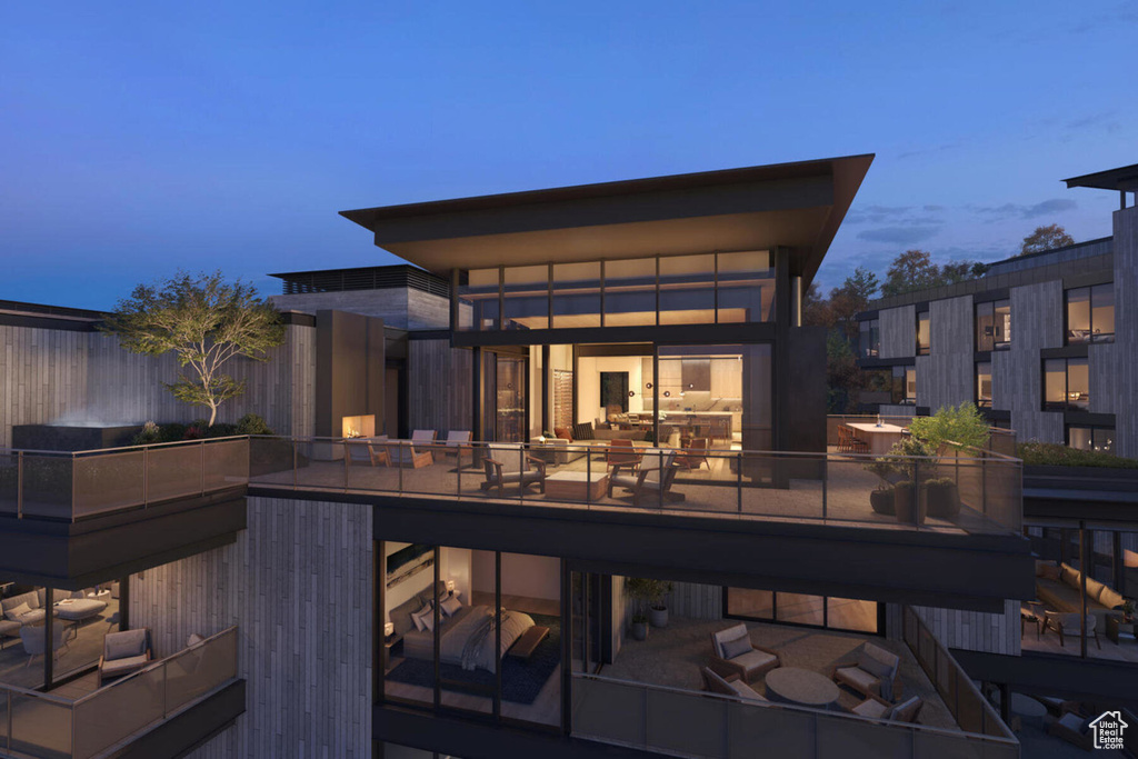 Back of property with a balcony