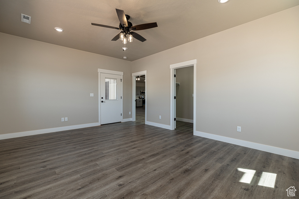 Spare room with a ceiling fan, baseboards, dark wood-style flooring, and recessed lighting