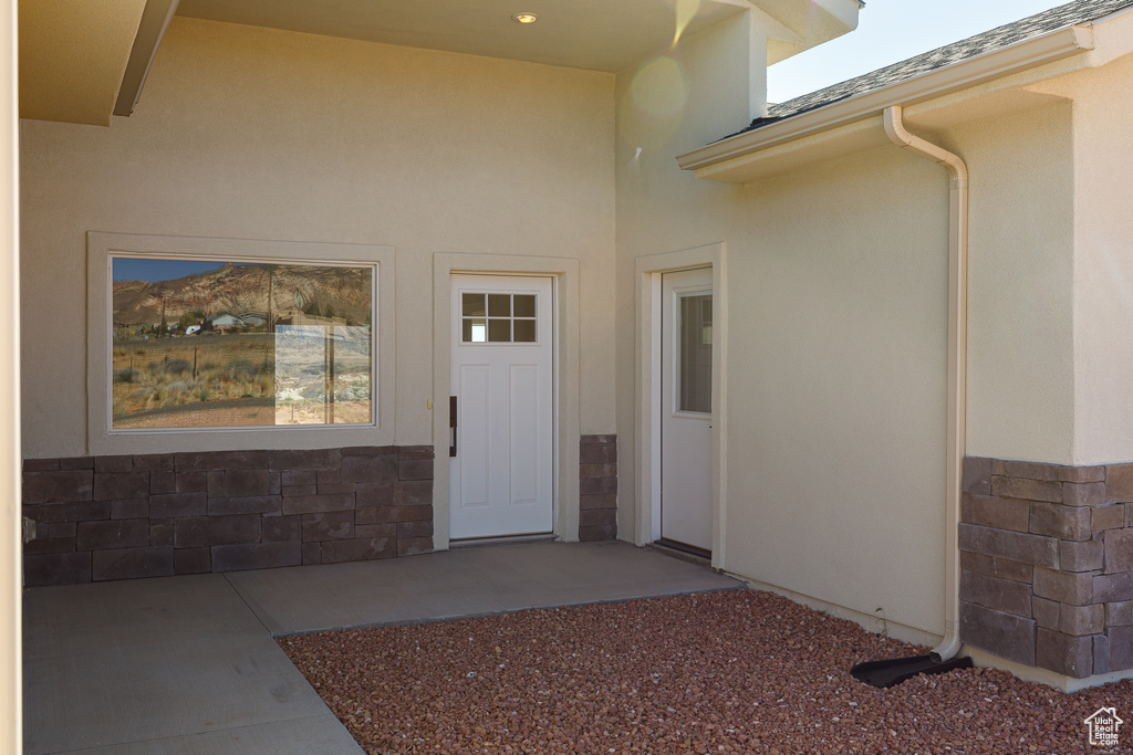 Doorway to property with stucco siding
