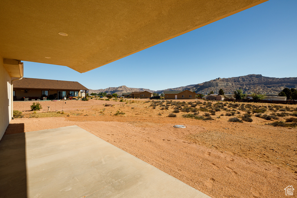 View of yard with a mountain view and a patio area
