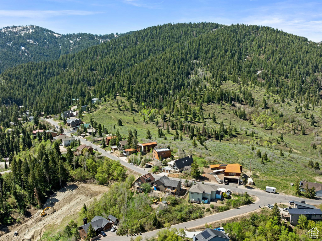 View of property location featuring a heavily wooded area and mountains