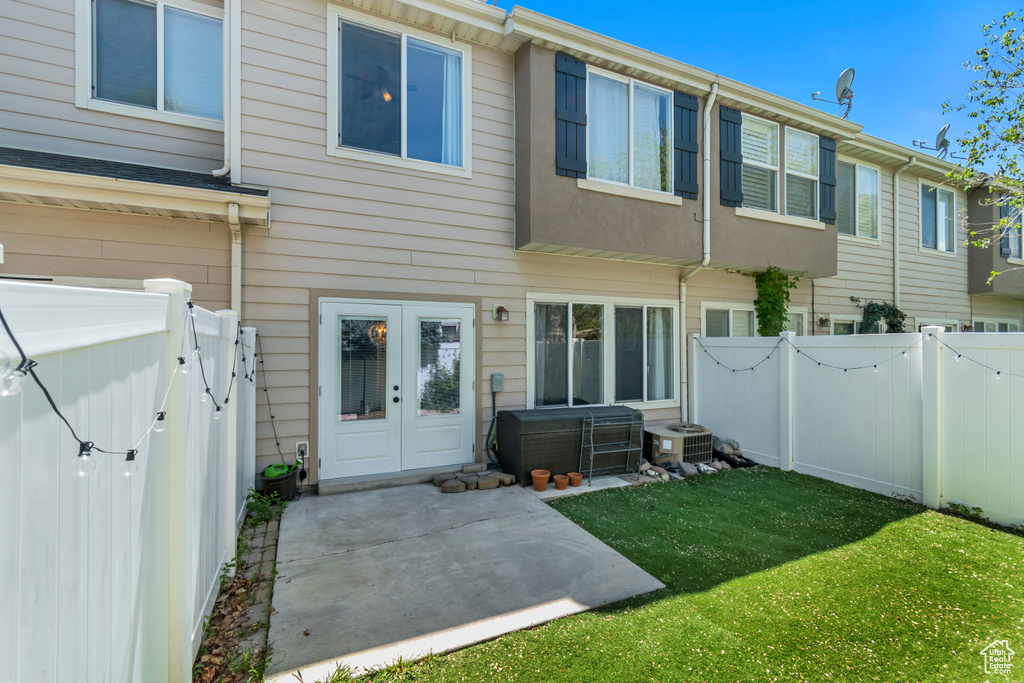 Back of house featuring a patio, cooling unit, french doors, and a gate