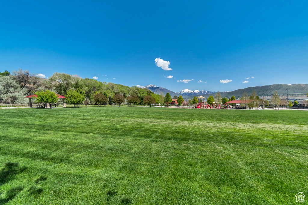 View of home's community with a mountain view and a yard
