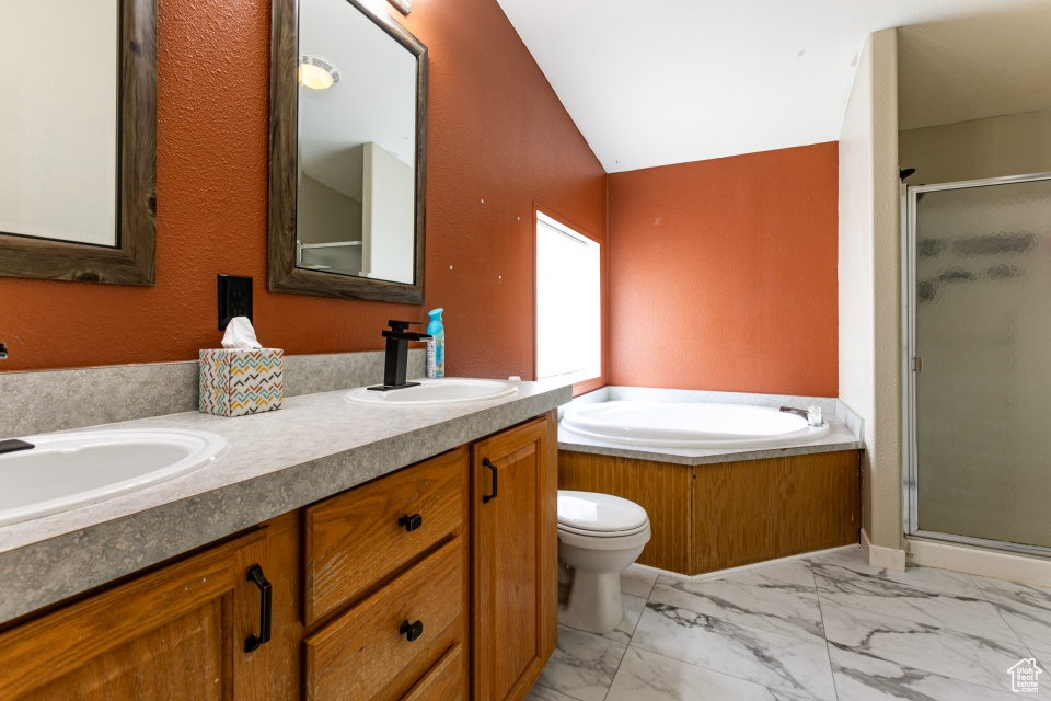 Full bath featuring a shower stall, marble finish floors, double vanity, a garden tub, and toilet