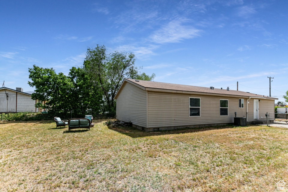 Rear view of house with central AC unit