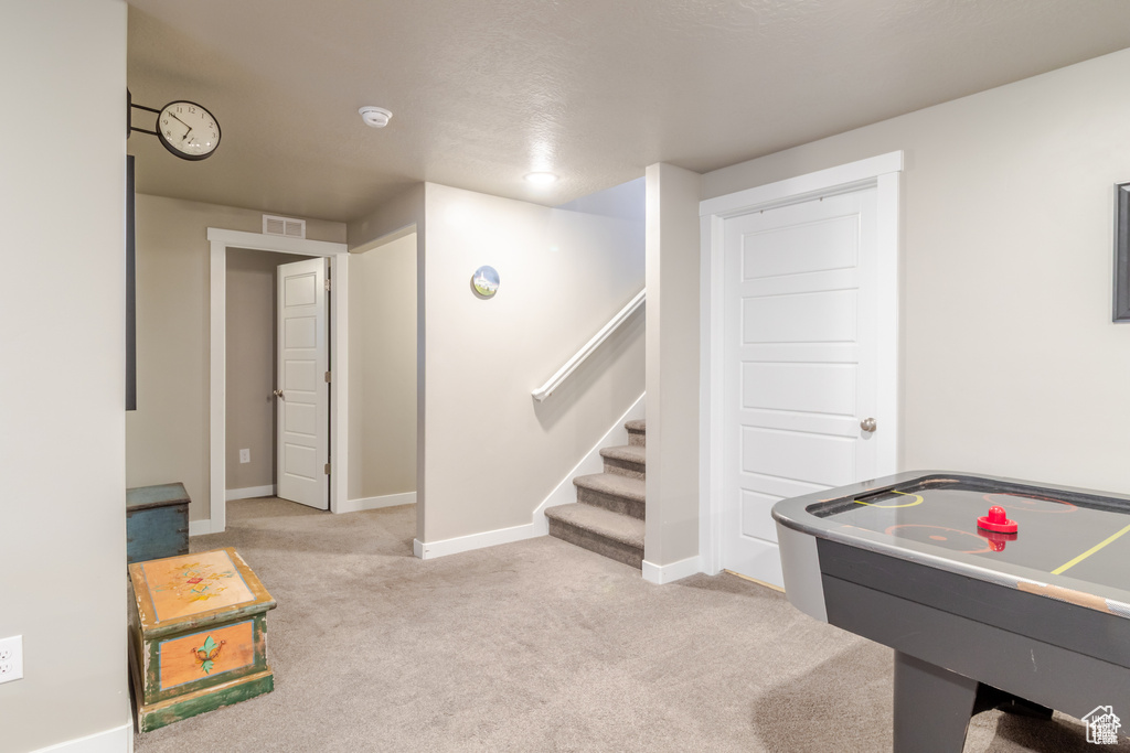 Game room featuring carpet floors and baseboards