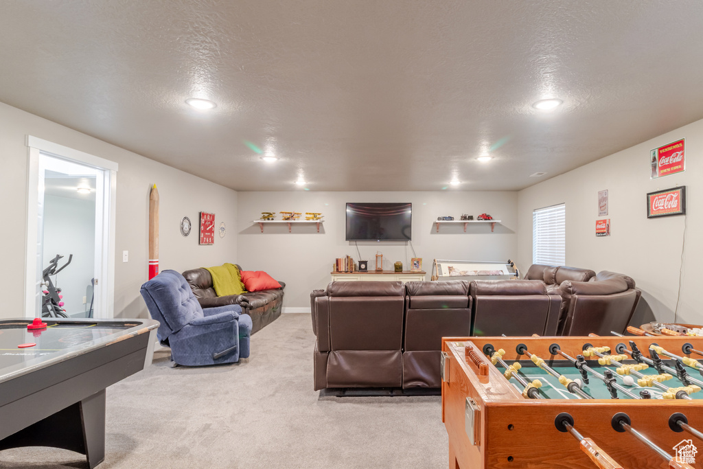 Playroom featuring light colored carpet, recessed lighting, and a textured ceiling