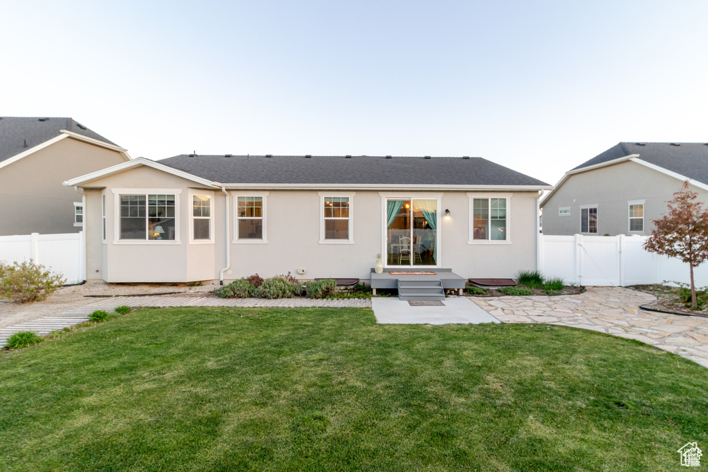 Back of house with a patio area and stucco siding