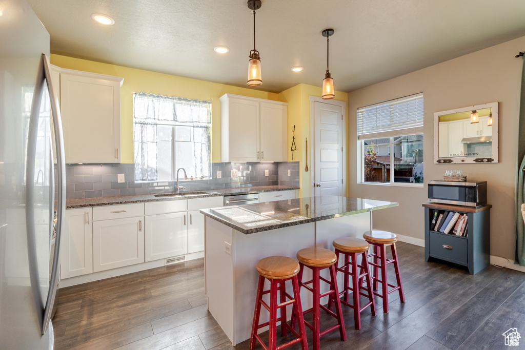 Kitchen featuring stainless steel appliances, a sink, dark wood-style flooring, healthy amount of natural light, and recessed lighting