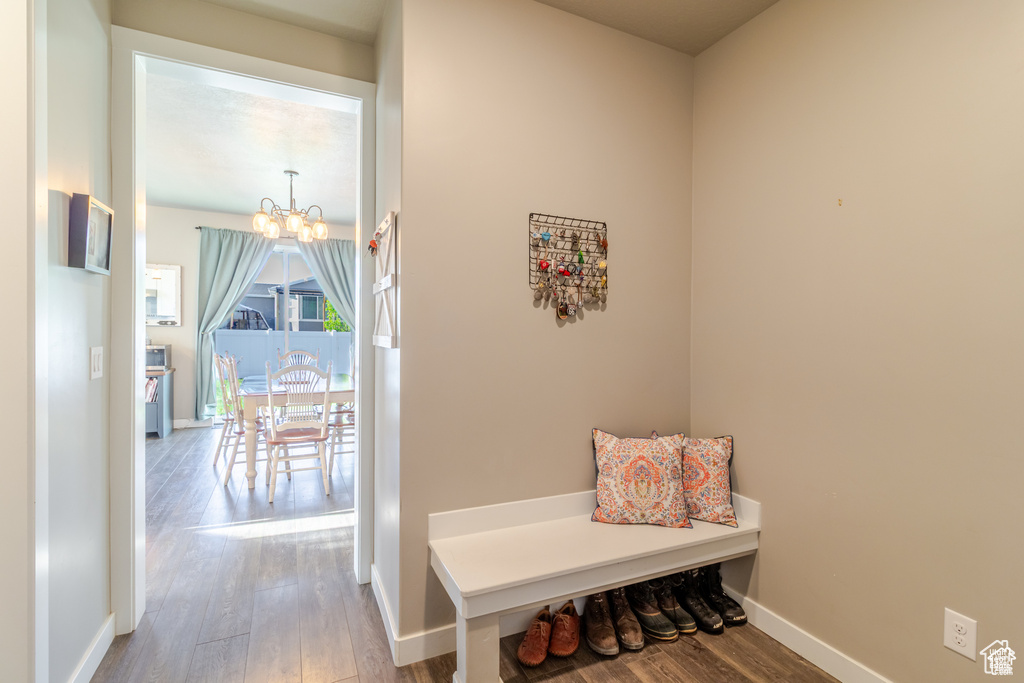 Mudroom with a chandelier, wood finished floors, and baseboards