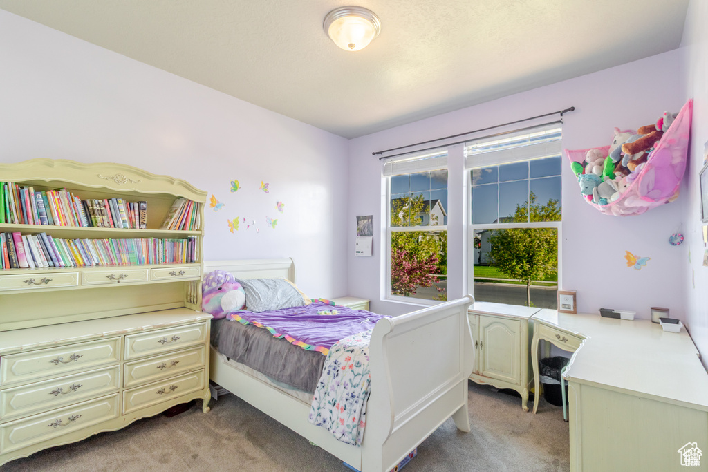 Bedroom featuring light carpet