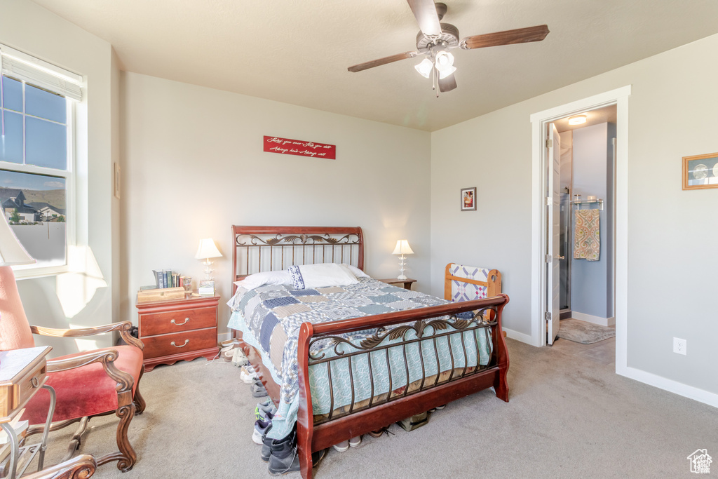 Bedroom with carpet floors, baseboards, and a ceiling fan