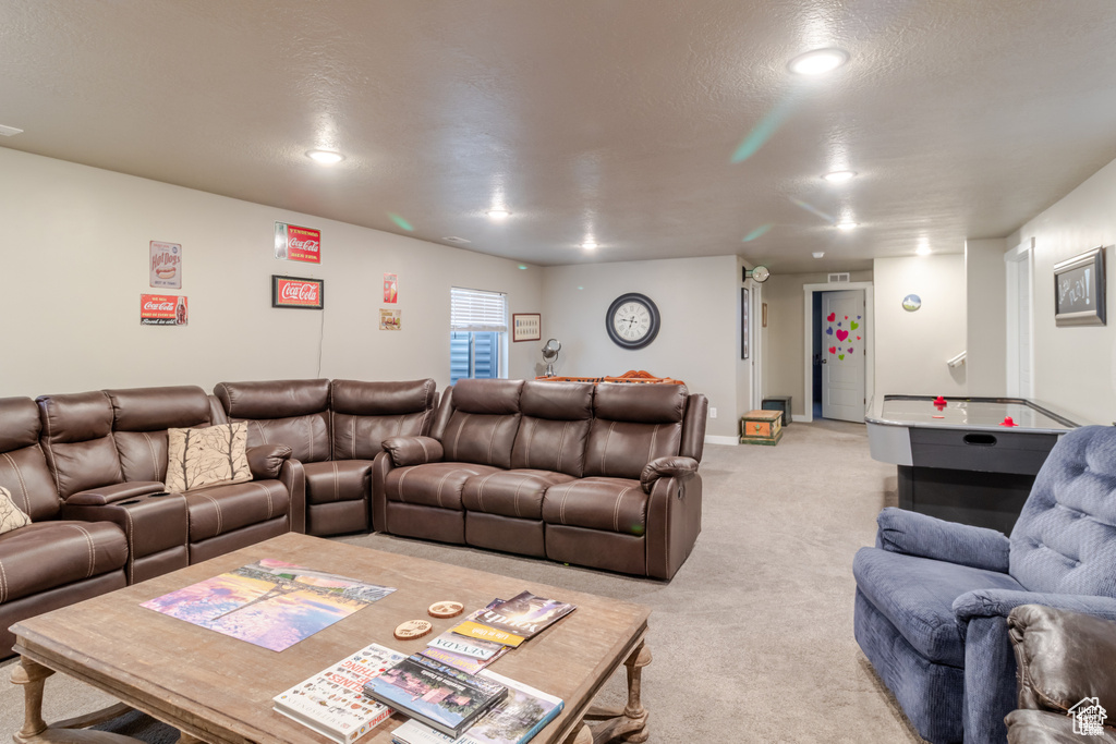 Living room featuring light colored carpet and recessed lighting