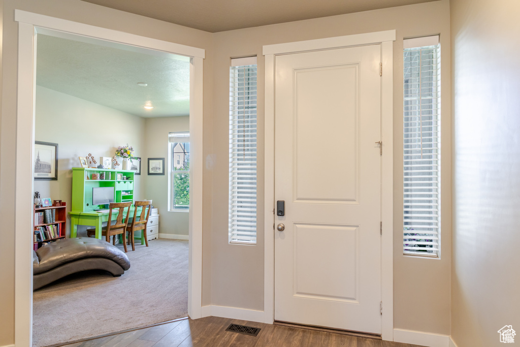 Entrance foyer featuring baseboards and wood finished floors