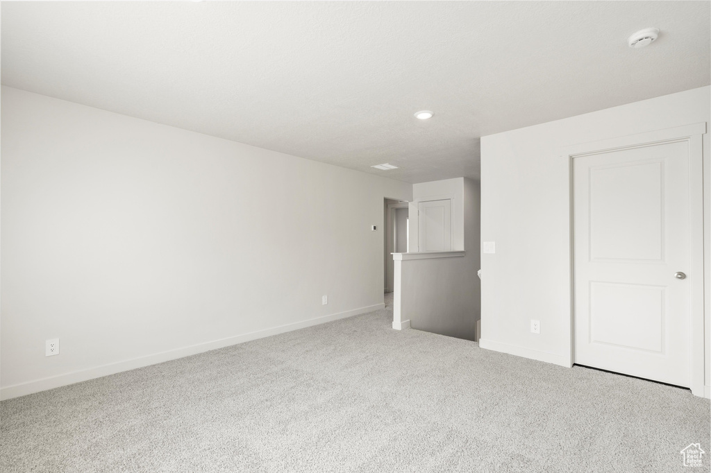 Unfurnished bedroom with carpet and recessed lighting
