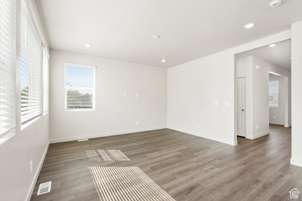 Unfurnished room with wood finished floors and recessed lighting