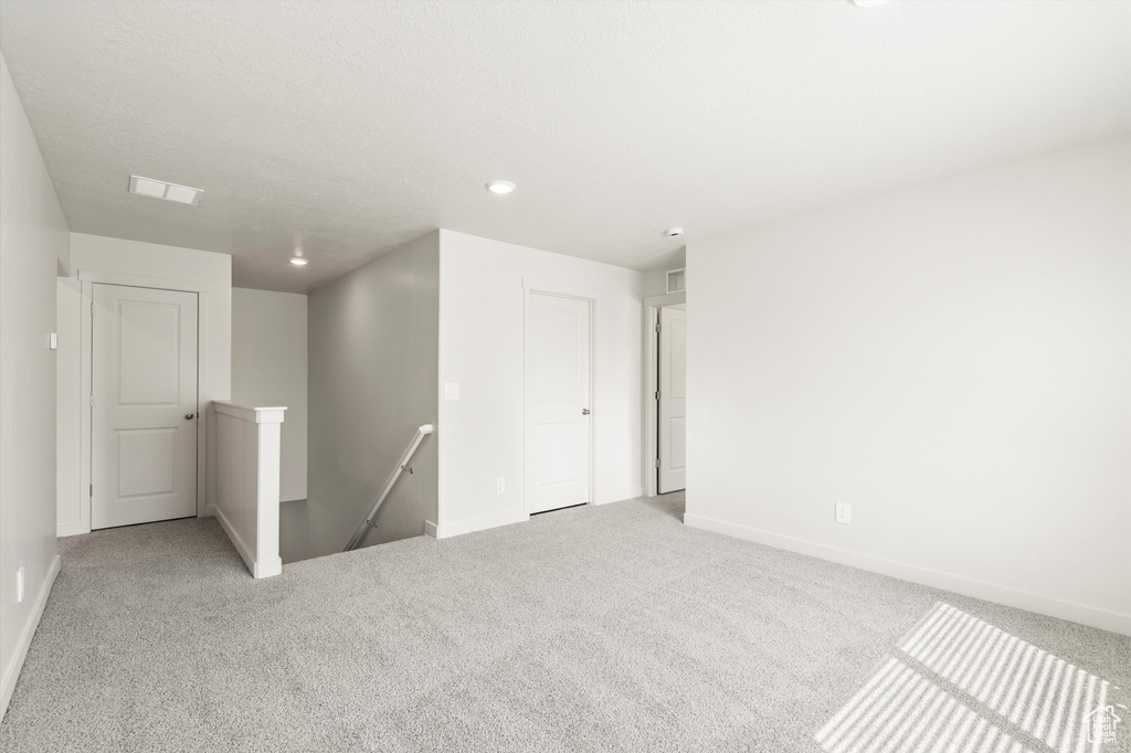 Unfurnished room featuring carpet flooring and recessed lighting