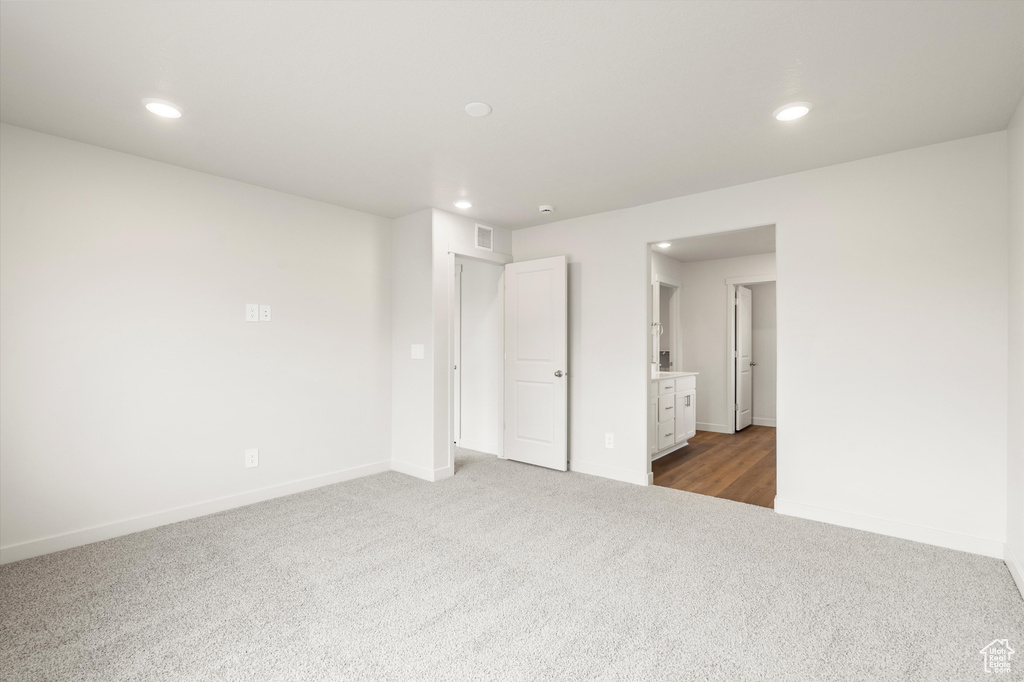 Unfurnished bedroom featuring dark carpet and recessed lighting