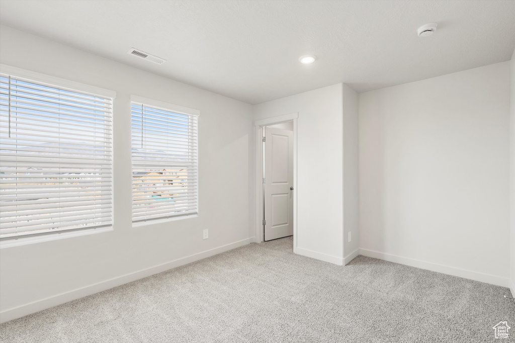 Unfurnished bedroom featuring light colored carpet and recessed lighting