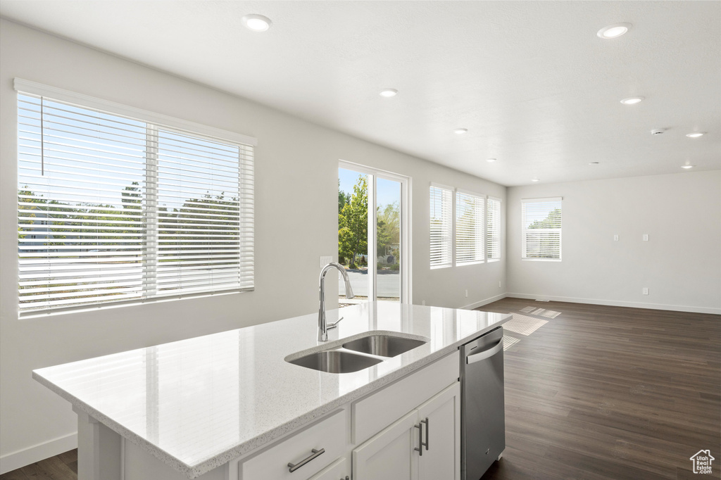 Kitchen with healthy amount of natural light, dishwasher, dark wood-style flooring, open floor plan, and recessed lighting