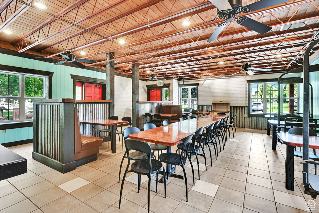 Dining space featuring a ceiling fan and tile patterned flooring
