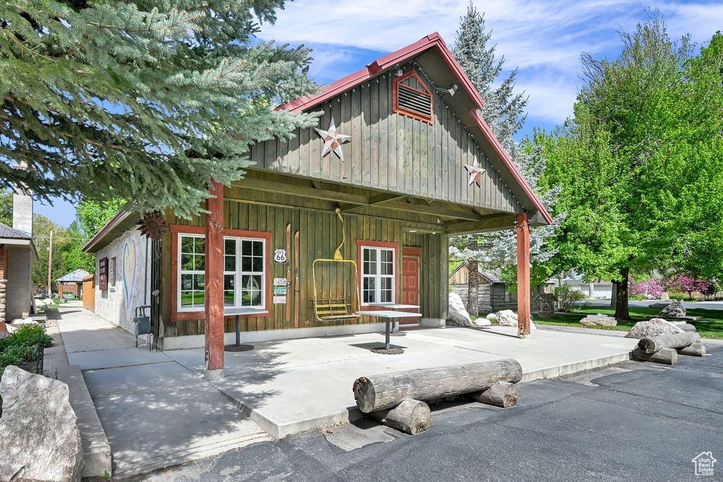 View of front of house featuring board and batten siding and a porch