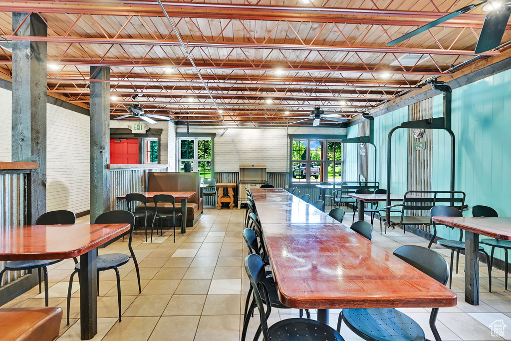 Dining area featuring a ceiling fan and light tile patterned flooring