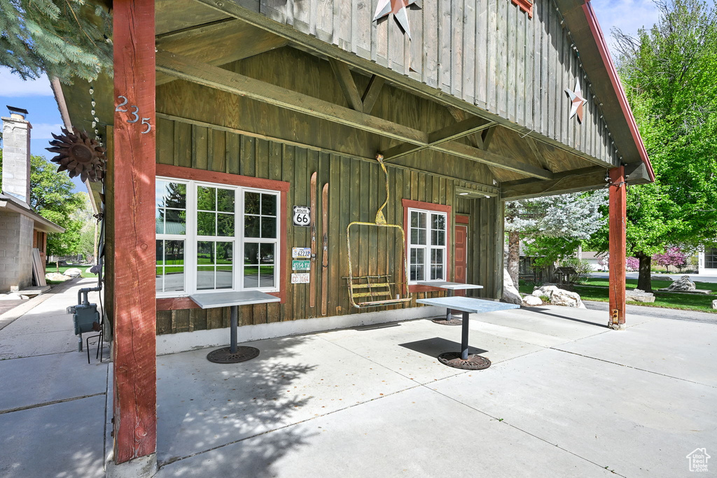 Entrance to property featuring covered porch and board and batten siding