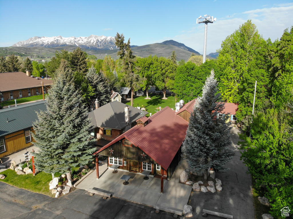 Aerial view of property and surrounding area featuring mountains