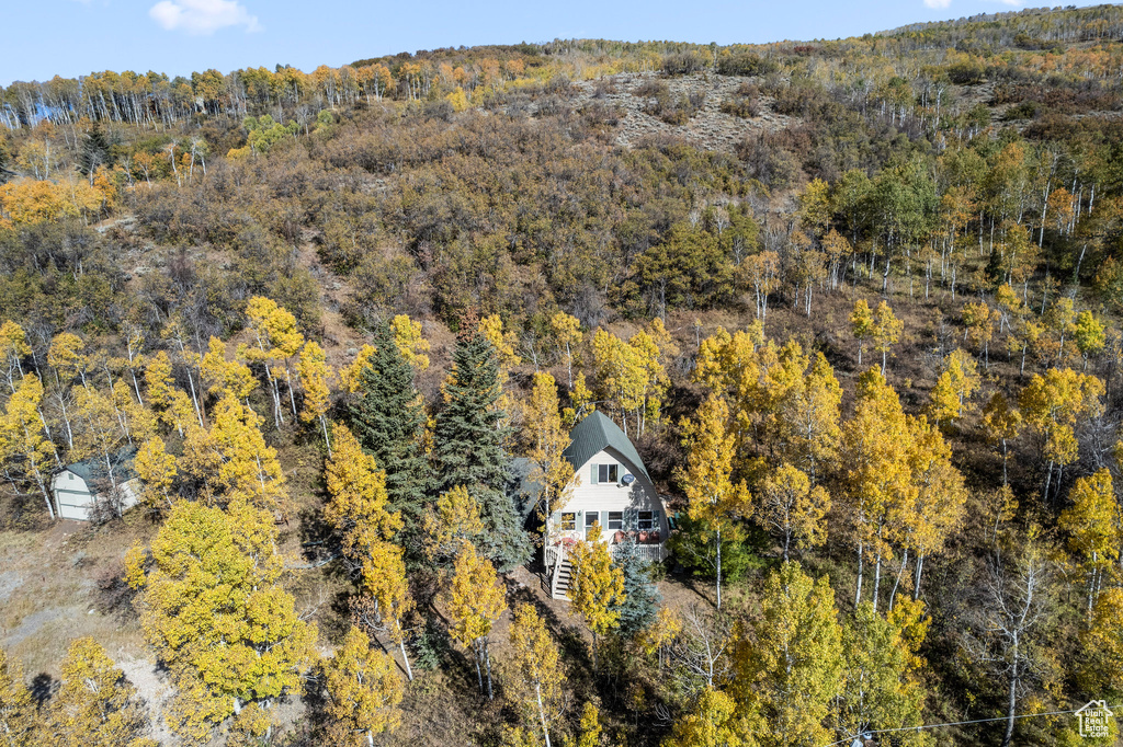 View of subject property with a heavily wooded area