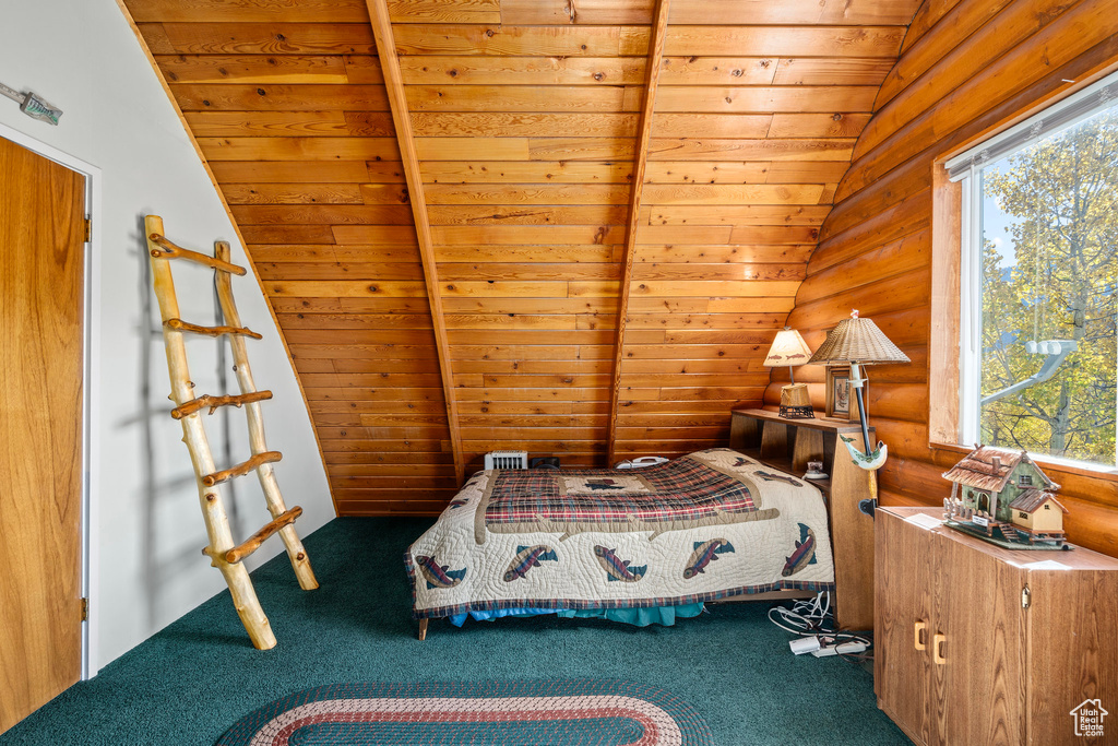 Carpeted bedroom with vaulted ceiling, multiple windows, and wooden ceiling