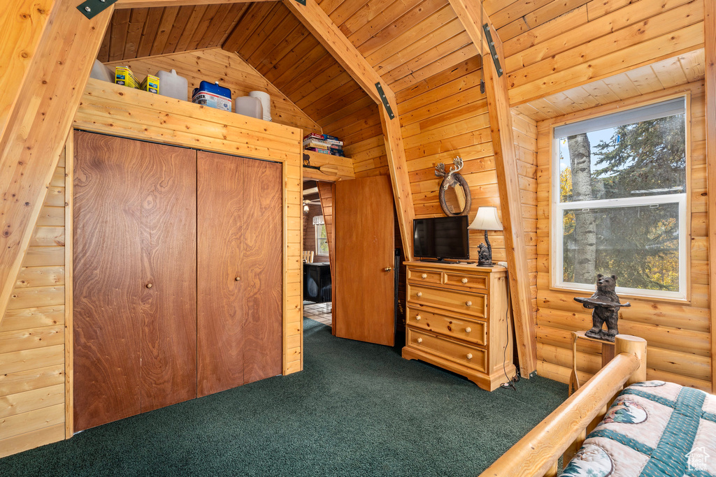 Bedroom with carpet, wooden ceiling, lofted ceiling, and wood walls